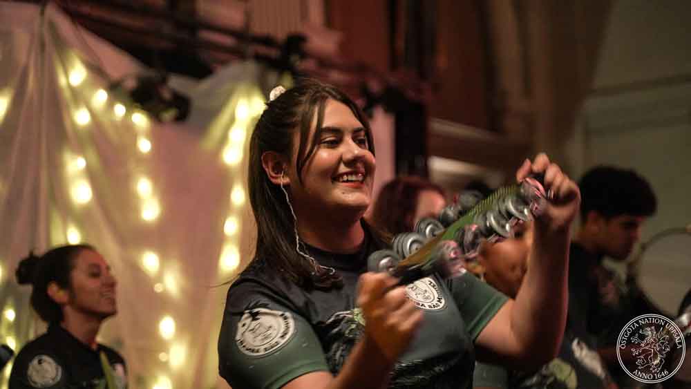 Chocalho player in action on stage.